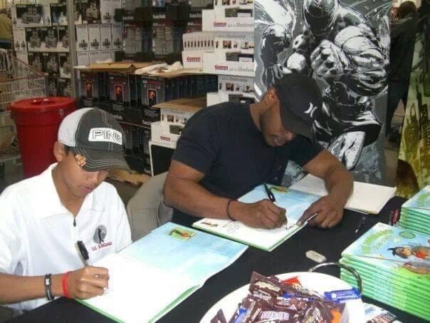 Johnny and Lil' Jordan signing books at a store event