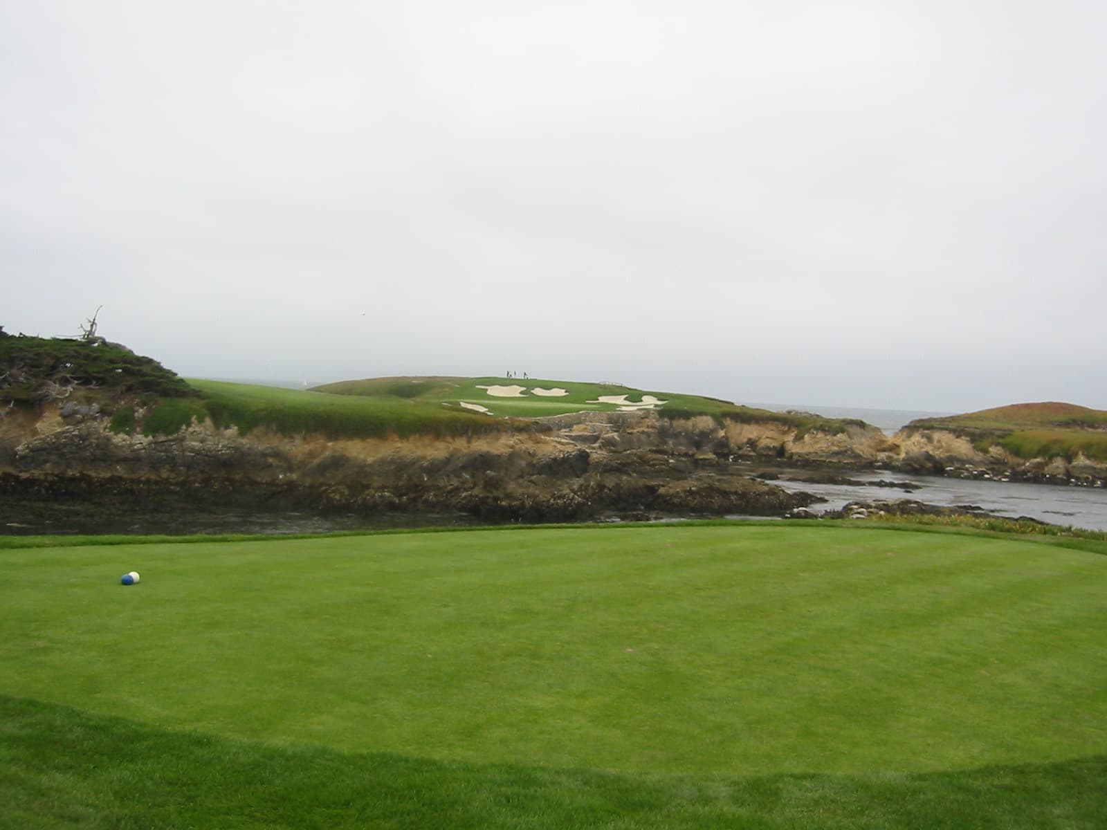 A tee box beside an ocean inlet at Cypress Point Club