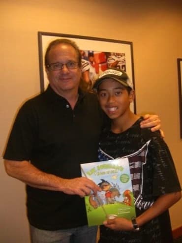 Lil' Jordan with a supporter holding the book