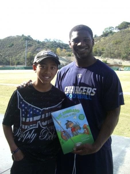 Lil' Jordan with a fan holding the book