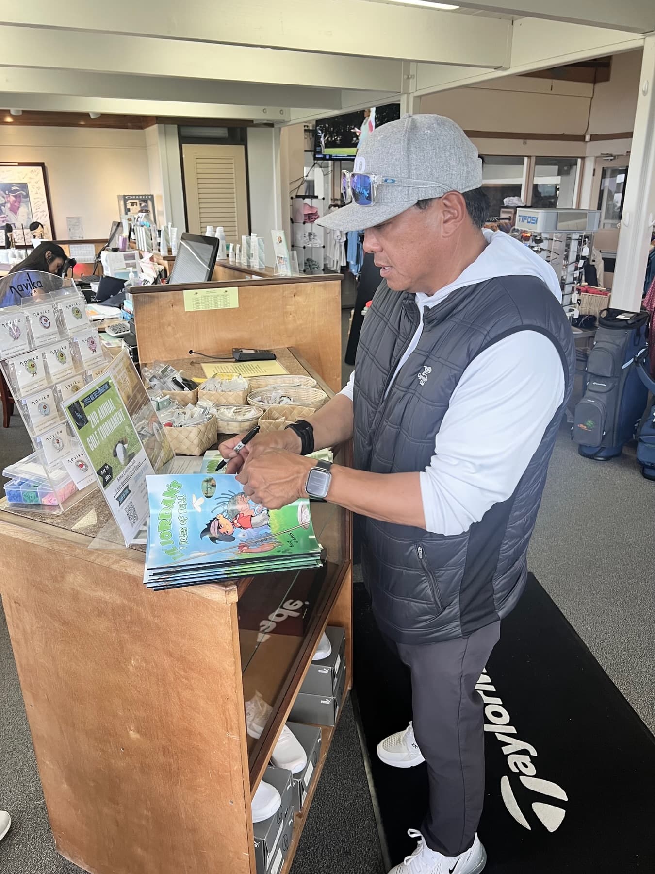 Signing copies of the book in a golf shop