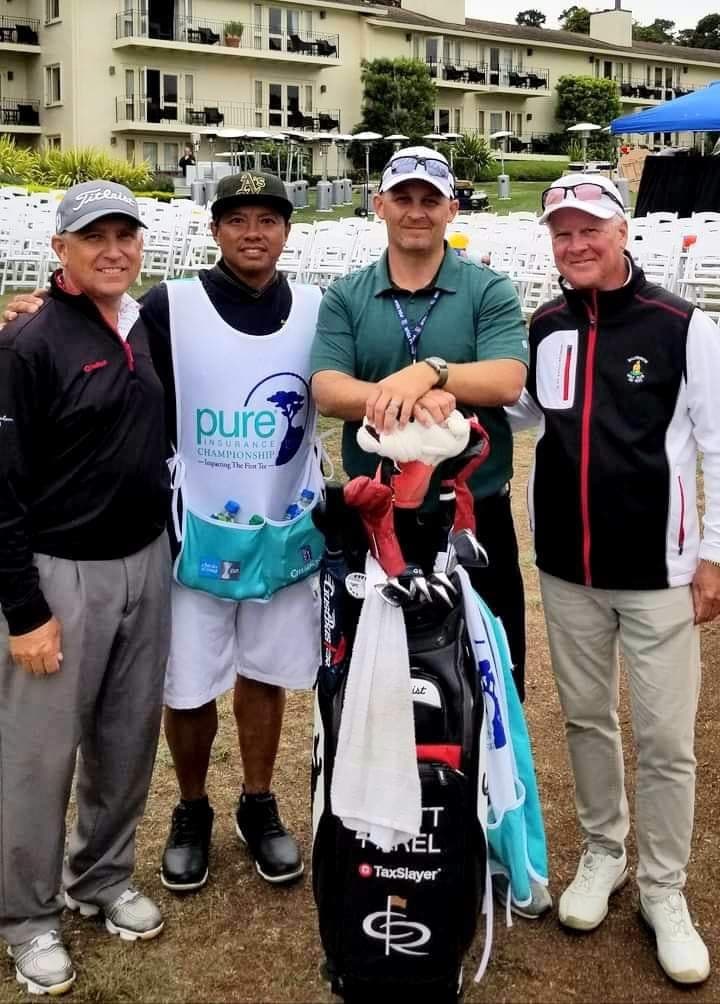 Johnny in a tournament caddie bib with his player's bag and the group